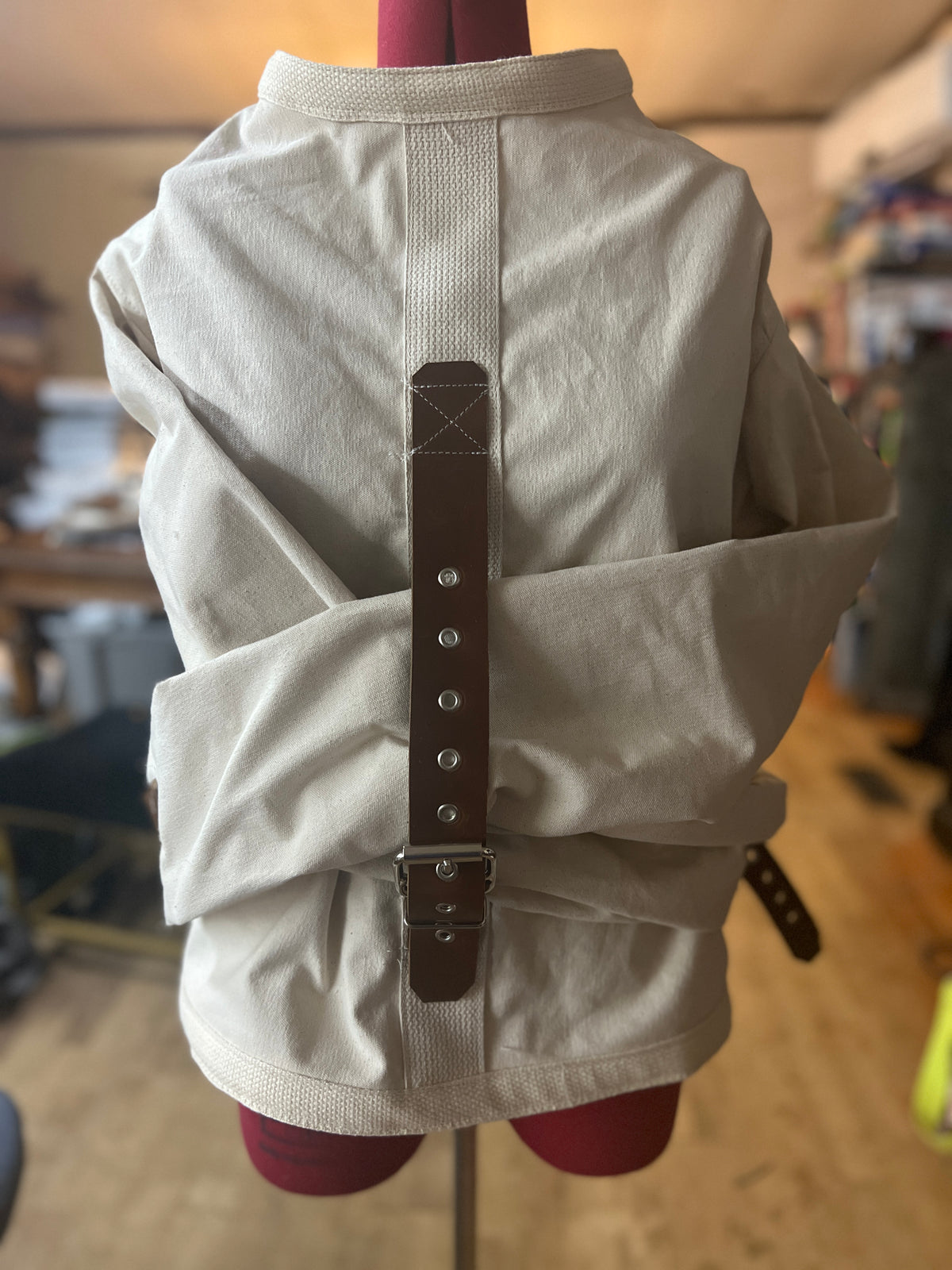 Brown leather strap straitjacket